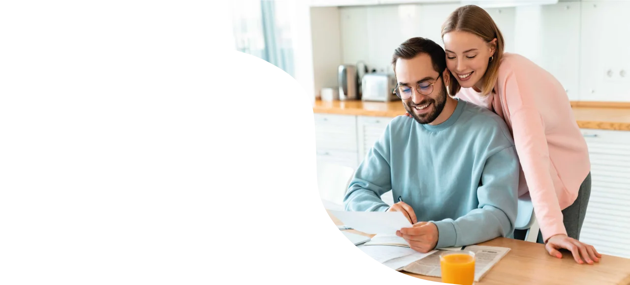 A homeowner reviewing their refinanced home loan paperwork with their broker